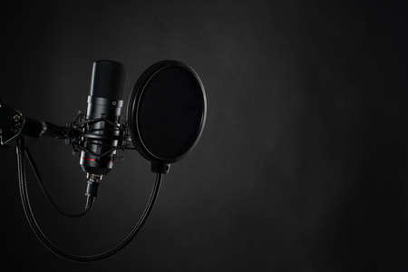 Proffesional studio microphone, isolated on the black background ready for podcasts recording.