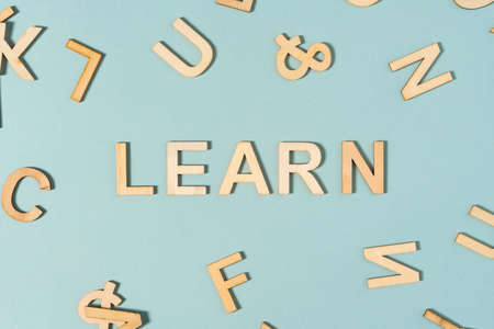 LEARN sign made by wooden letters on the green background, flat layの写真素材