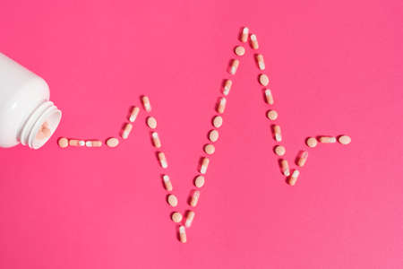 an EKG pattern made by a lot of pink pillsの写真素材