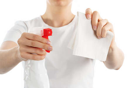 A close up image of woman holding a cleaning spray in hand isolated on white background