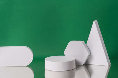 Geometric composition of figures on the colorful bakcground. Empty showcase podium for cosmetic presentationの写真素材