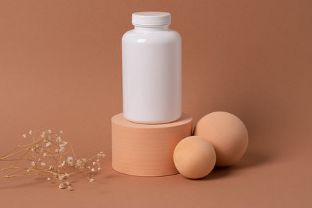 White bottle of medication pills with blank label placed on the geometric figures on the colorful background. Aesthetic composition for product placement.の写真素材