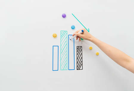 Image of white magnetic board with bussines chart report.