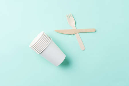 Wooden cutlery on the green background. Eco friendly tableの写真素材