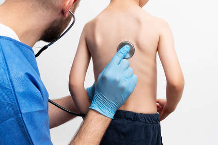 Close up picture of doctor examining a little bou withの写真素材