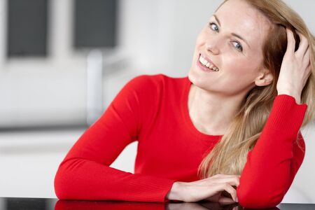 Young woman relaxing in the kitchen at homeの写真素材