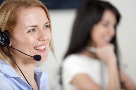 Two colleagues working in a busy call centre office.の写真素材