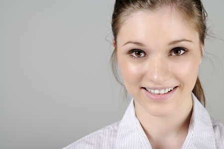 Young woman in smart shirt facing the cameraの写真素材