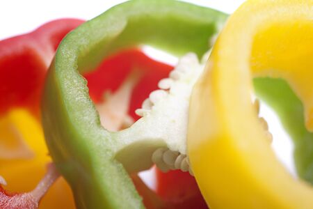 Red Yellow and Green peppers sliced on an isolated white backgroundの写真素材