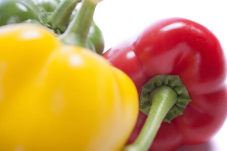 Red Yellow and Green peppers laid out next to each otherの写真素材