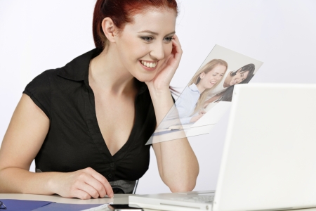 Young woman holding a conference call with colleagues over the internet.の写真素材