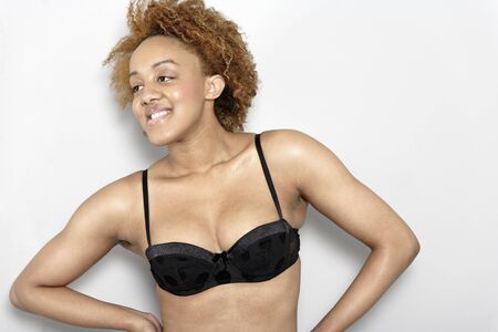 Sexy young black woman in lingerie smiling in lingerie smilingの写真素材
