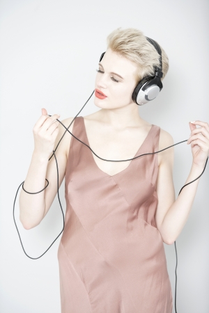 Attractive young woman listening to music through headphonesの写真素材
