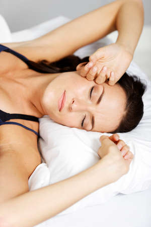 Young woman having a sleep in bed.の写真素材