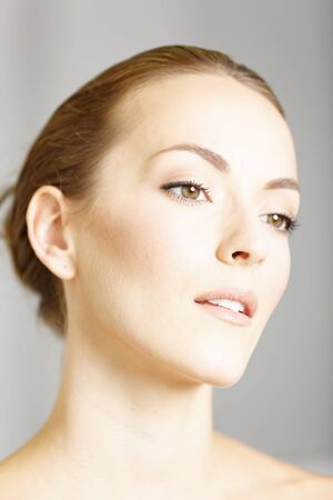 Beautiful young womans face in a beauty style poseの写真素材