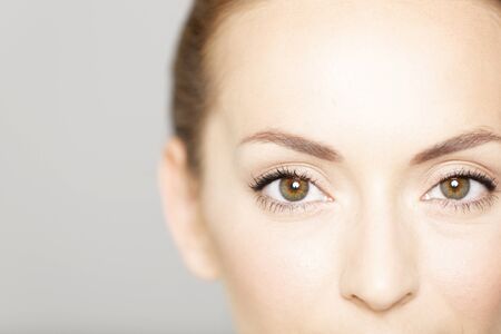 Cropped around the eyes of a young female in a beauty style poseの写真素材