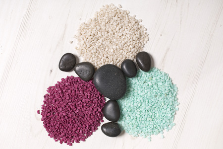 Three piles of white red and blue sand with smooth peoples boring the pilesの写真素材