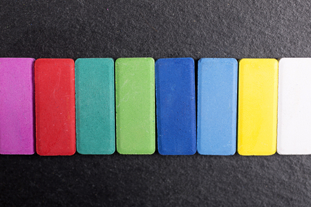 Colourful paint palette selection on a black slate surfaceの写真素材