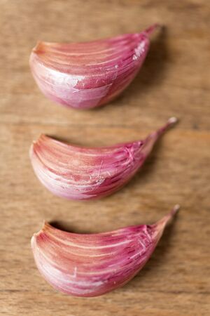 Fresh raw garlic on a wooden kitchen work surfaceの写真素材
