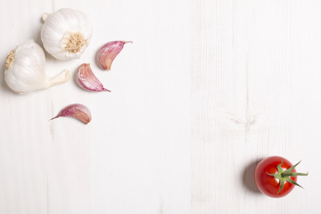 Fresh raw garlic on a light wooden kitchen work surfaceの写真素材