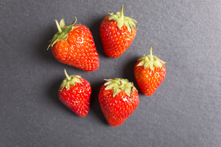 Fresh ripe strawberries on black slateの写真素材