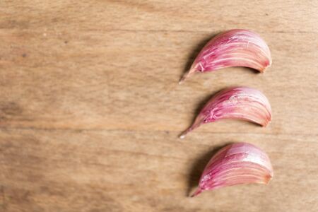 Fresh raw garlic on a wooden kitchen work surfaceの写真素材