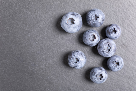 Summer ripe blueberries on black slateの写真素材