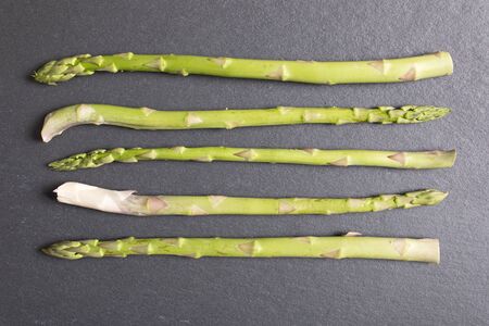 Selection of fresh Asparagus on black slate with copy spaceの写真素材