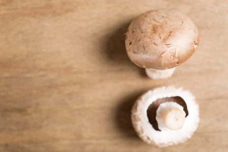 Selection of fresh raw mushrooms on a wooden kitchen work surfaceの写真素材