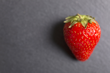 Fresh ripe strawberries on black slateの写真素材