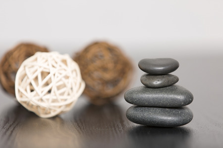Pile of three spa stones with three scented wicker ballsの写真素材