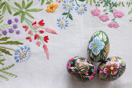 traditional easter eggs on floral tableclothの写真素材