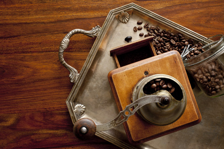 grinder and coffee beans on tableの写真素材