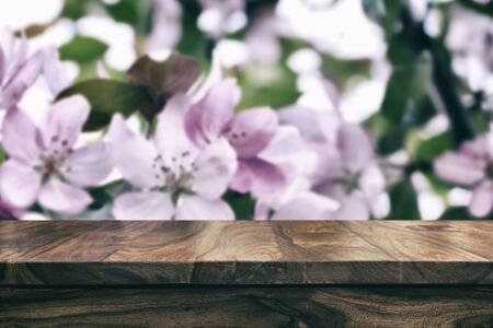 Empty top wooden table and floral blurred backgroundの写真素材