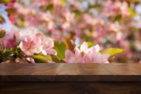 Empty top wooden table and floral blurred backgroundの写真素材