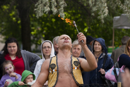 WARSAW, POLAND, June 1: Juggler with blazing torches during a performance on "Children's Day" party June 1, 2017 in Warsaw, Poland.のeditorial素材