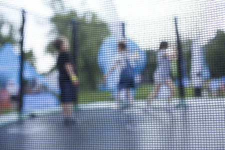 Blurry photo of kids having fun on a trampoline