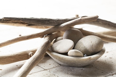 Pebbles with drift wood for mineral spa treatmentの写真素材