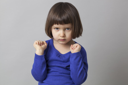 thoughtful young girl focusing and concentrating on instructionsの写真素材