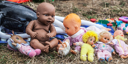 display of old dolls and baby dolls in plastic and fabric sold at flea market for antique collectionの写真素材