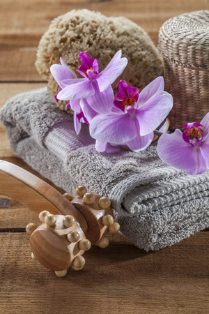 beauty ritual for spa treatment with natural sponge, towel, flowers and massage accessoryの写真素材