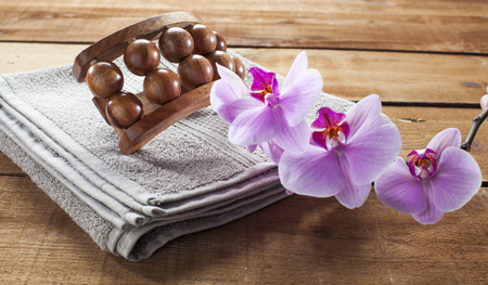concept of massage and washing-up with towel, wooden accessory and orchid flowers for relaxationの写真素材