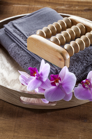 beauty ritual for spa treatment with natural sponge, towel, flowers and massage accessoryの写真素材