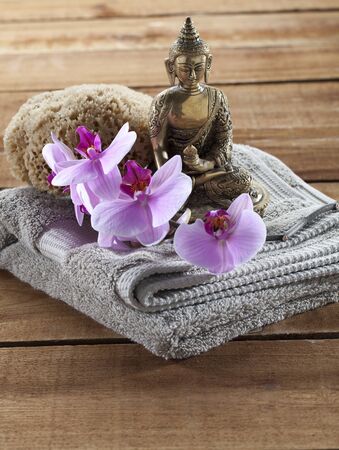 Buddha for spirituality at beauty spa with towel flower massage and ritual accessoriesの写真素材