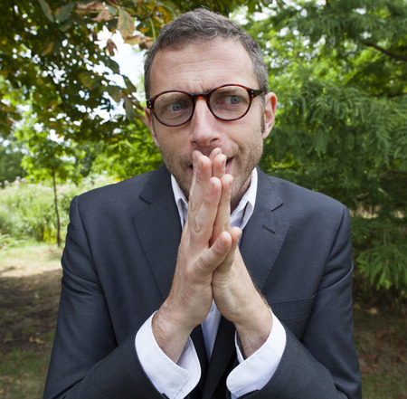 mad scientist outdoor concept - imaginative businessman discussing with passionate hand gesture in green background for corporate leadership,natural summer daylightの写真素材