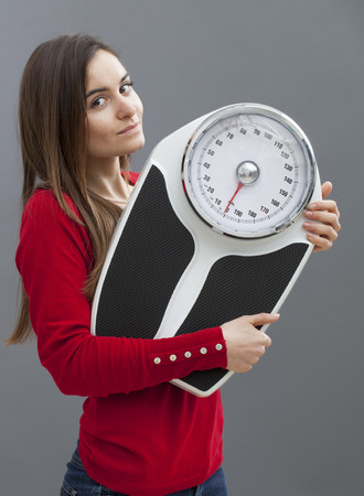 smiling 20s woman taking care of her health with weight controlの写真素材