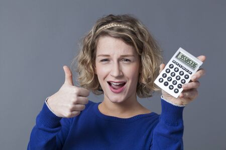 positive female businesswoman with calculator in handsの写真素材