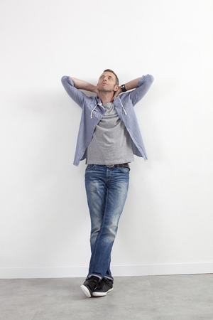 expressive casual man concept - relaxed middle age man standing against white wall with outstretched arms expressing imagination,white backgroundの写真素材