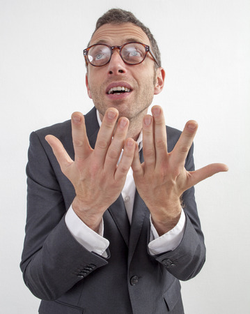 expressive corporate man concept - fun middle age businessman with hand gesture begging for management or leadership solution,wide angle on white backgroundの写真素材