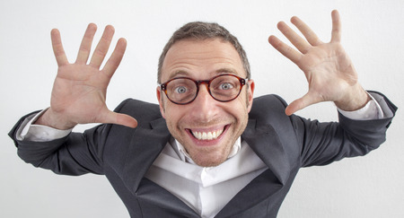expressive corporate man concept - humorous middle age businessman holding his hands for management responsibility,wide angle on white backgroundの写真素材
